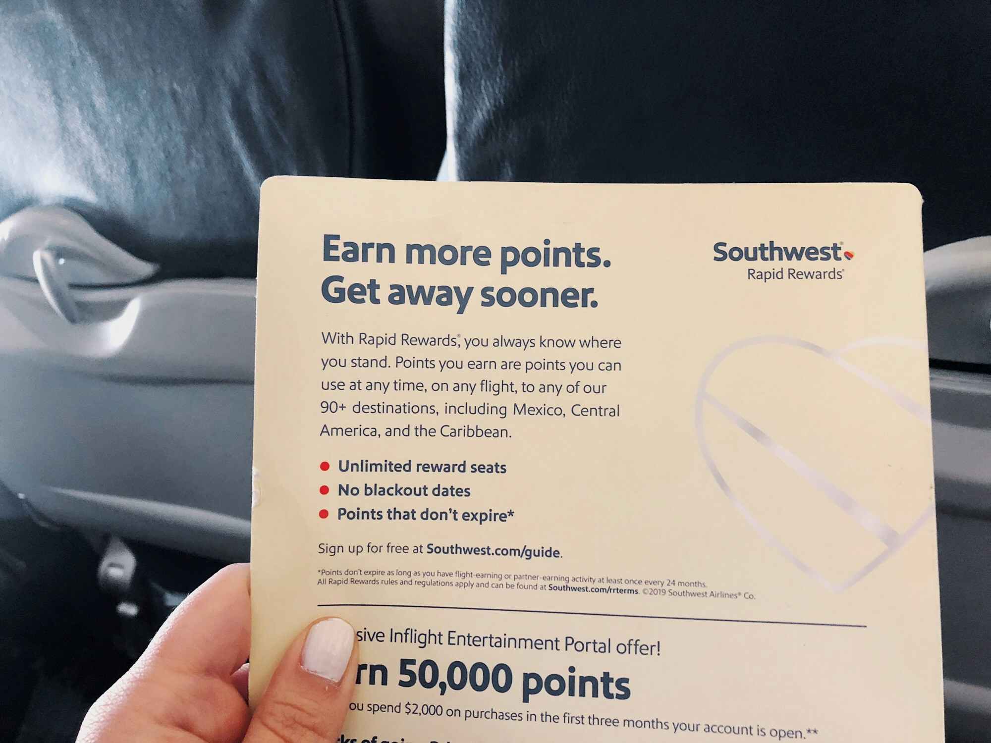 person holding southwest rapid rewards paper