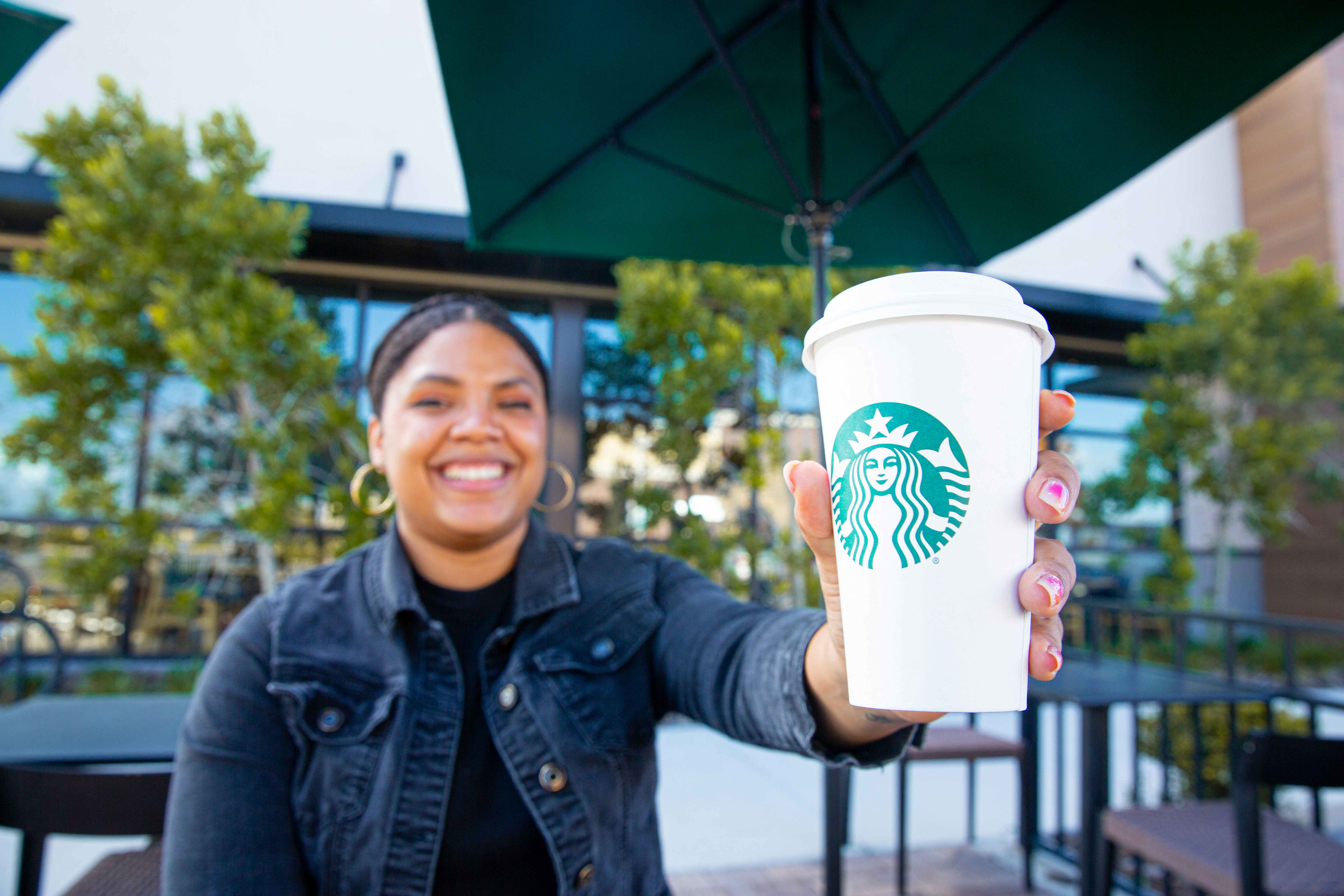 Person holding a cup of starbucks