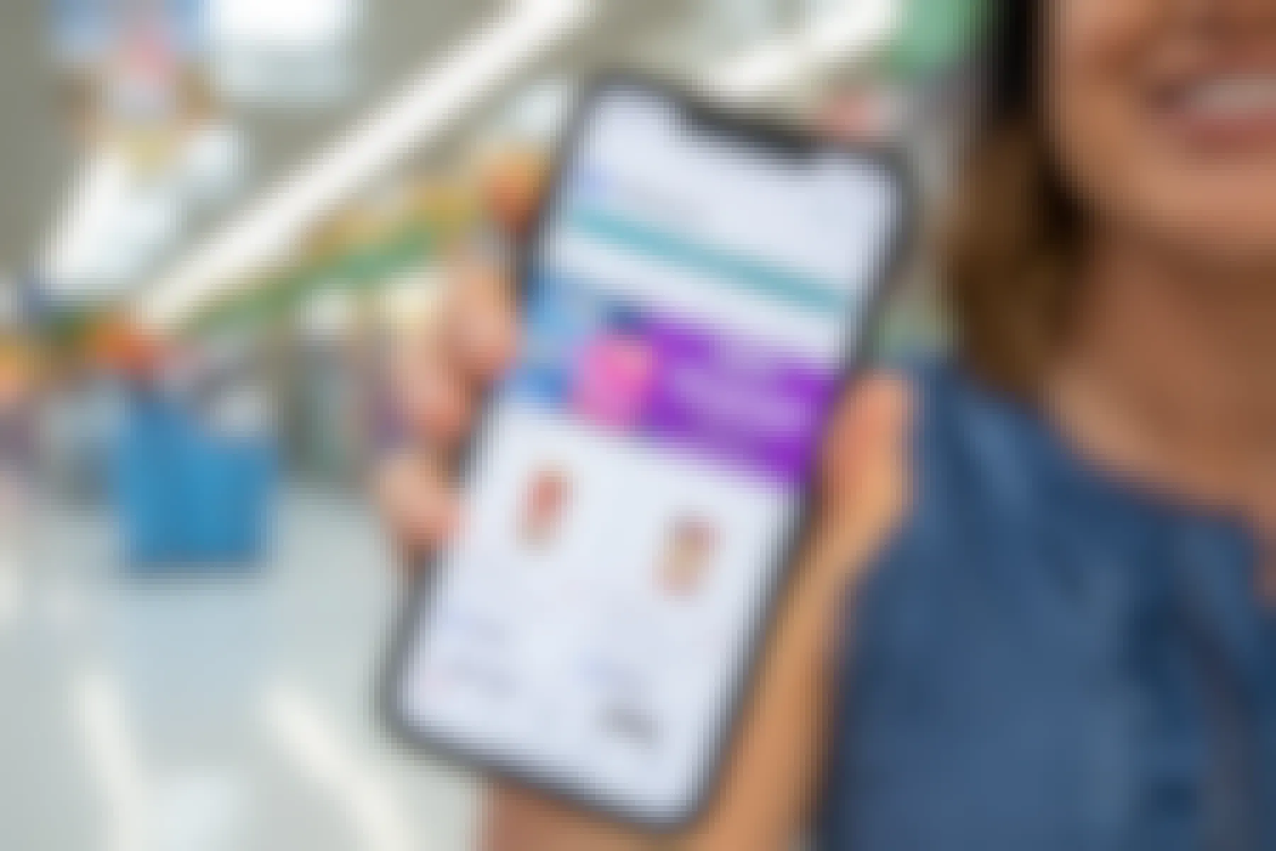 A person holding a smartphone with the ibotta app walmart section displayed.