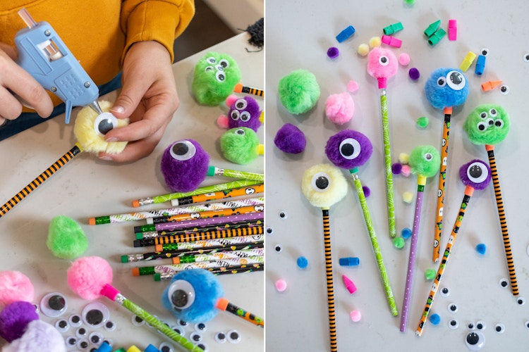 A person making little monsters by hot gluing pom pom balls and goggly eyes onto Halloween pencils.