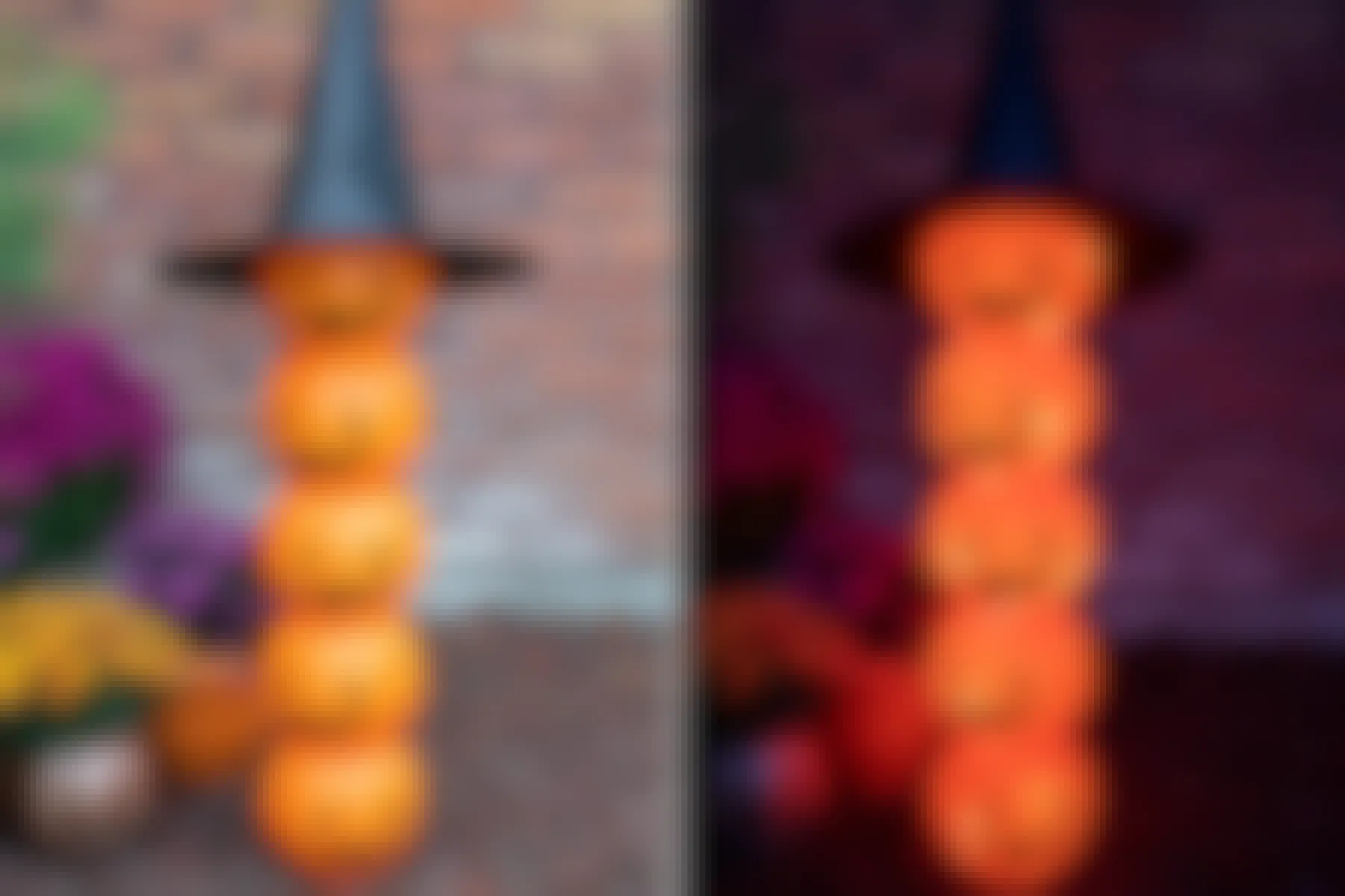 A light-up Halloween pumpkin totem made from plastic trick-or-treat pumpkin pails and a witch hat set up in a garden.