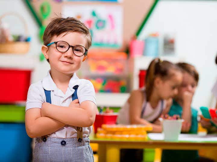 kid in glasses playing legos