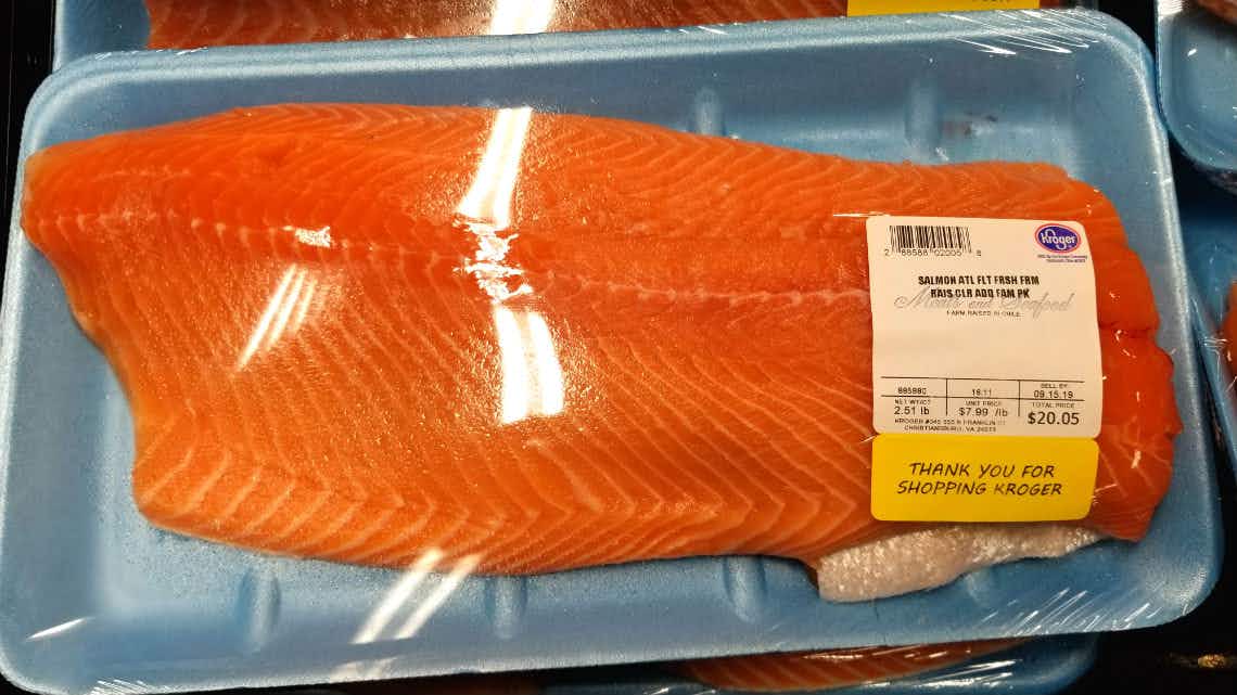 A salmon filet package with a price label.