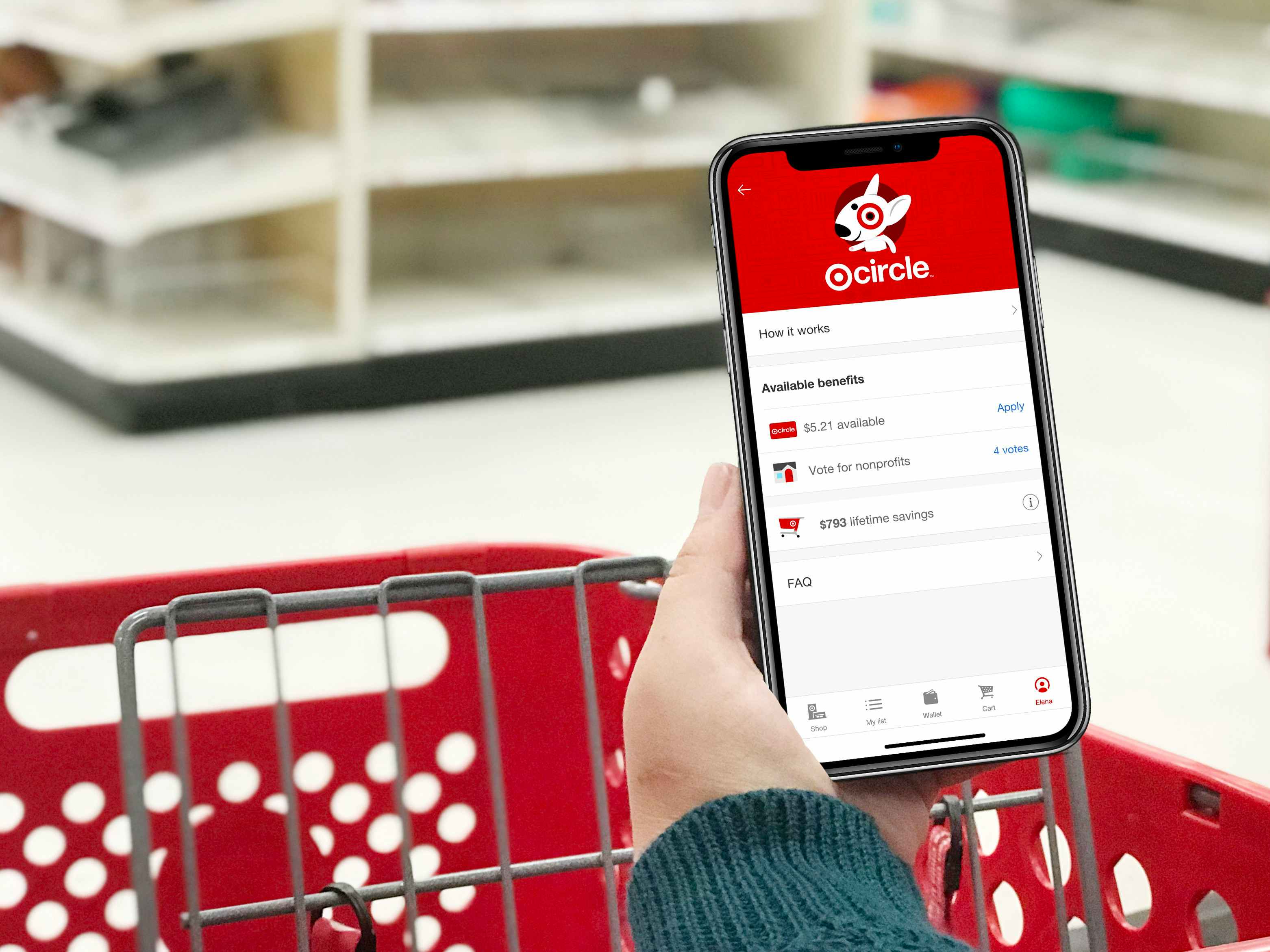 a person holding their phone with the target app open while pushing a target cart