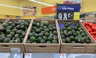 avocados in tan crates in front of a walmart everyday low price sign indicating $0.98