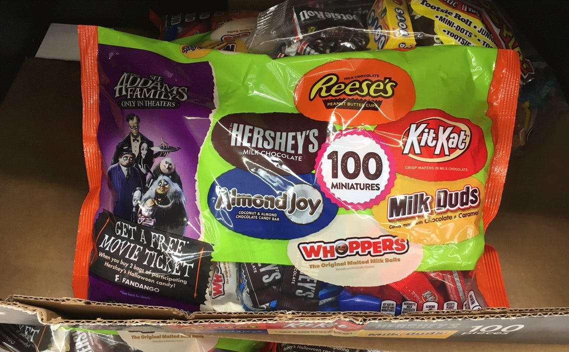 A bag of assorted Halloween candy miniature chocolates on a shelf at a store.