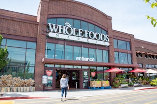 an outside view of a Whole Foods storefront from the parking lot