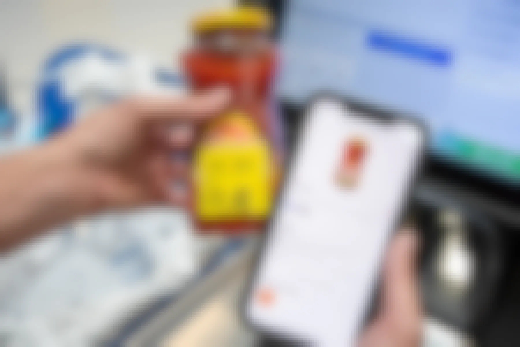 A person's hands, one holding a jar of Pace Medium Picante Salsa with a sticker showing the price as $1.48, and the other hand is holding up an iPhone with a rebate mobile app open showing the same product qualifying for $0.25 back.