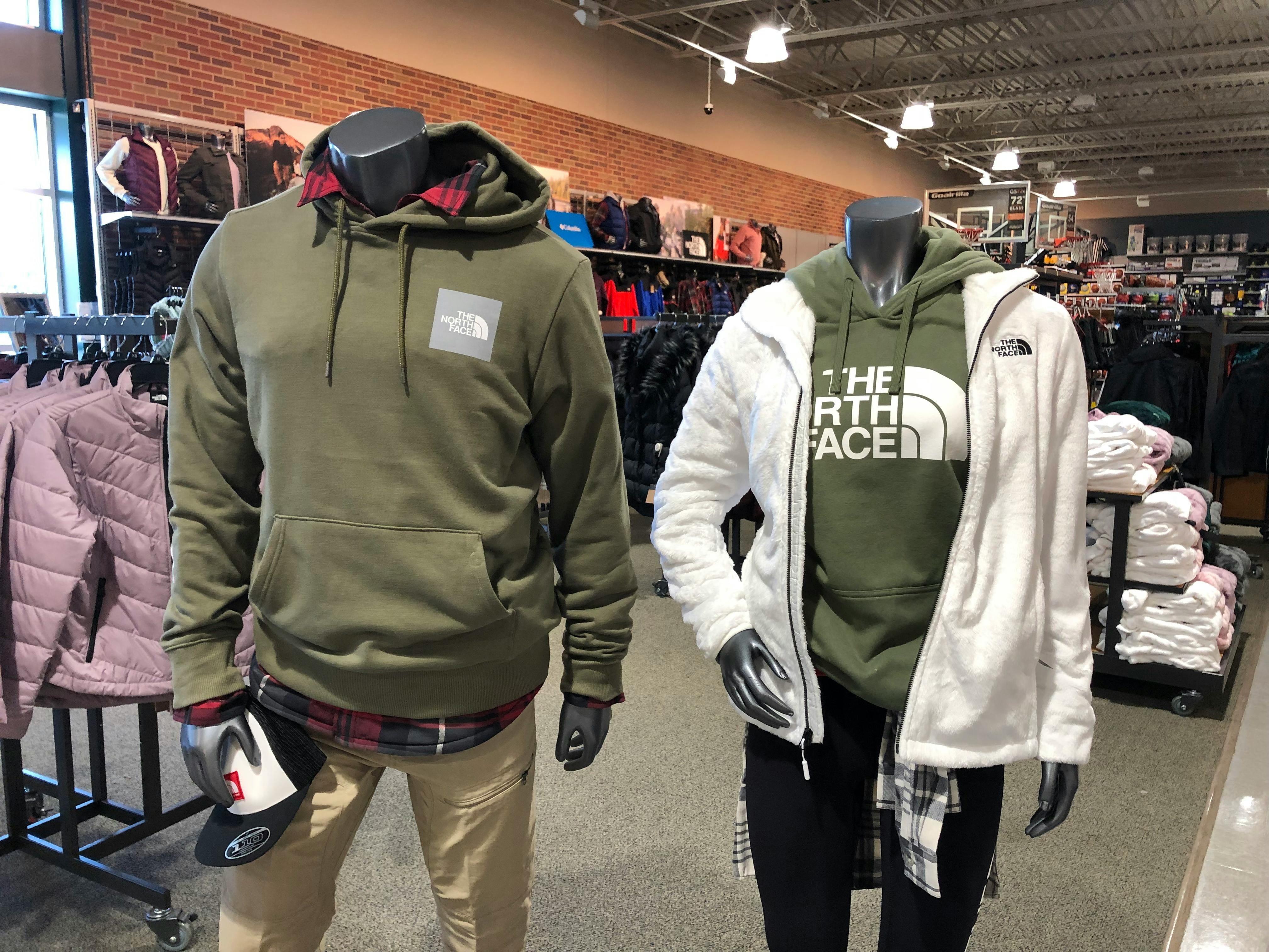 man and woman mannequin wearing north face gear at dicks sporting goods