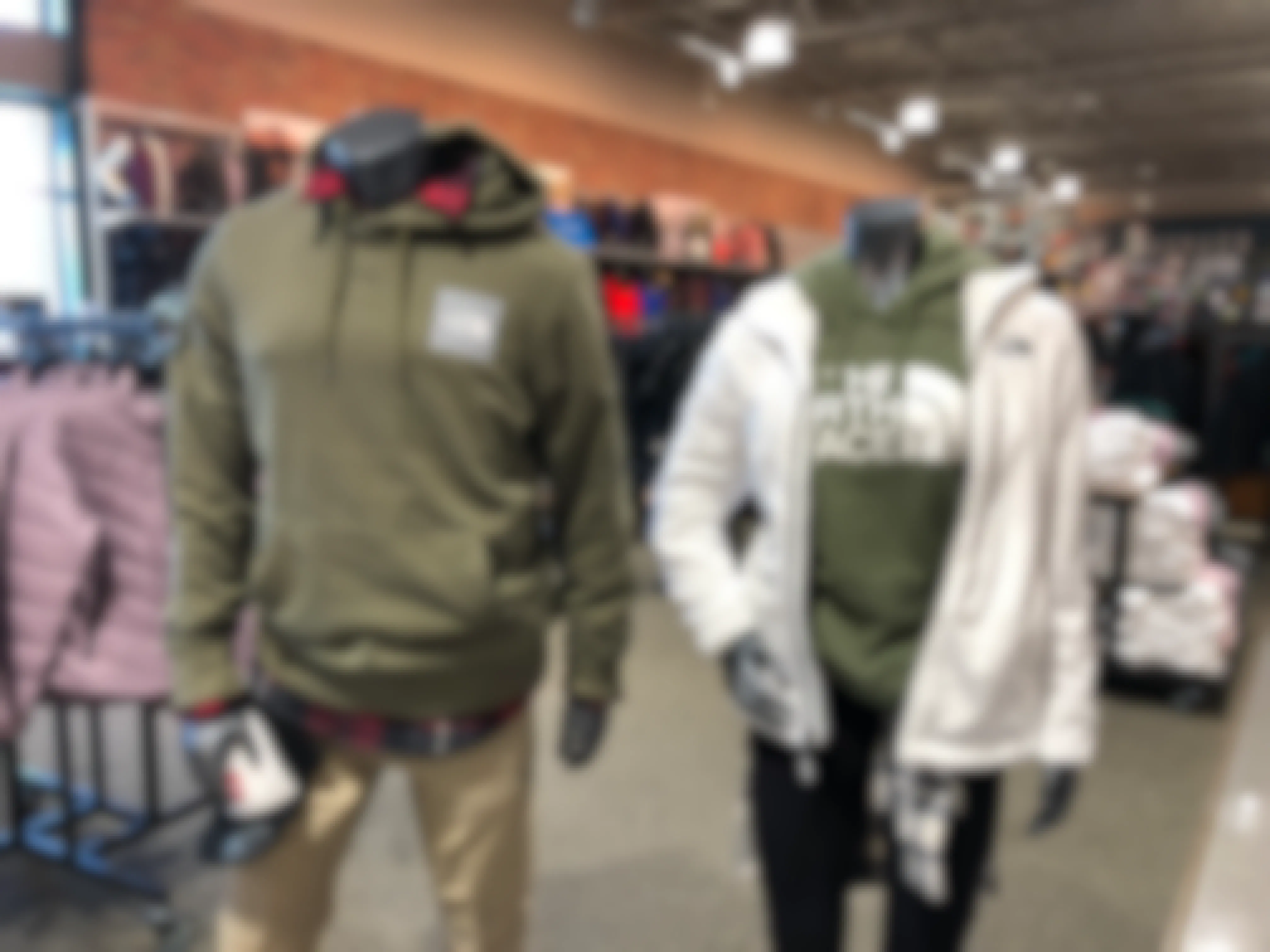 man and woman mannequin wearing north face gear at dicks sporting goods