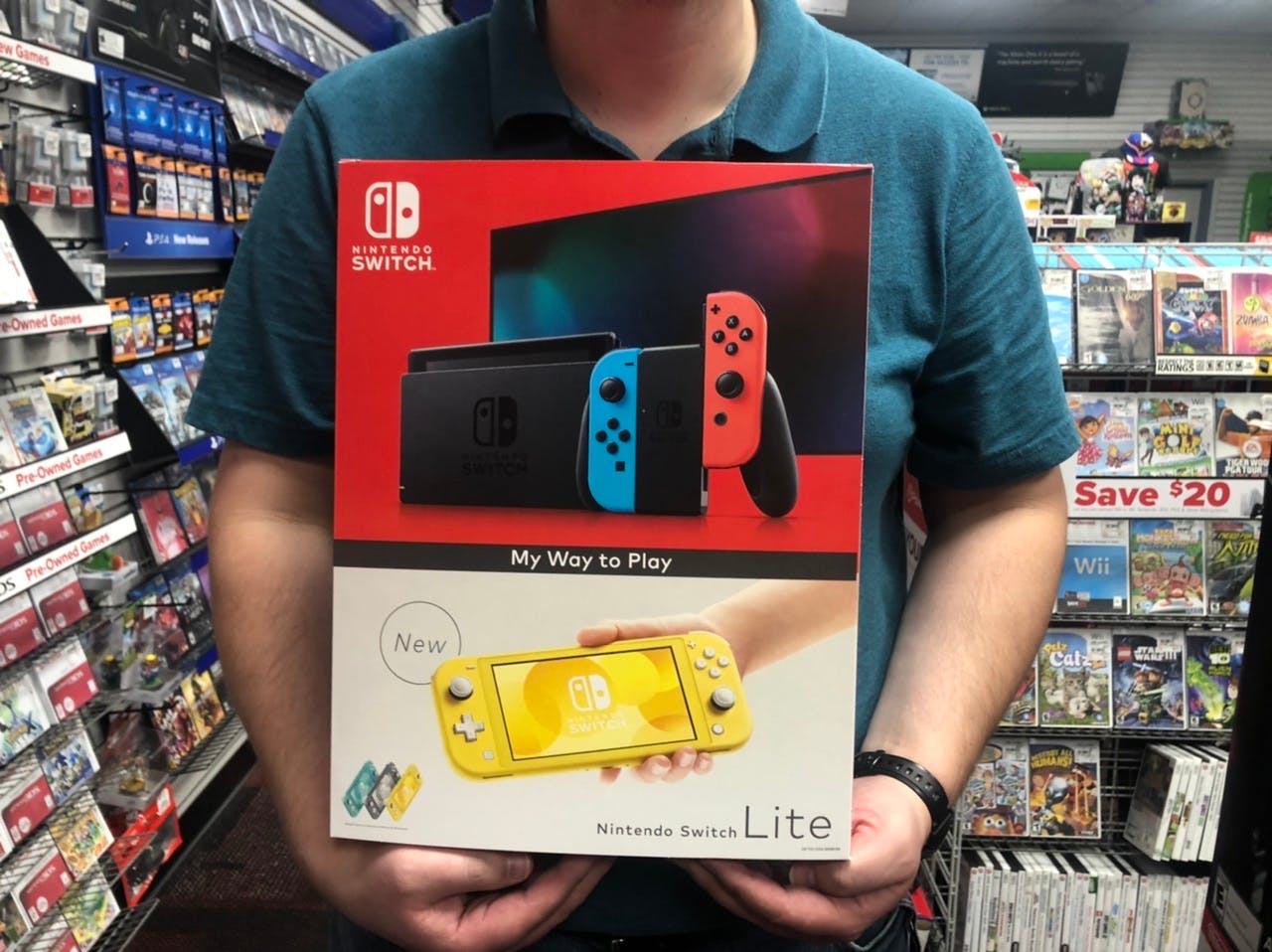 A man holds a box for Nintendo switch lite in GameStop
