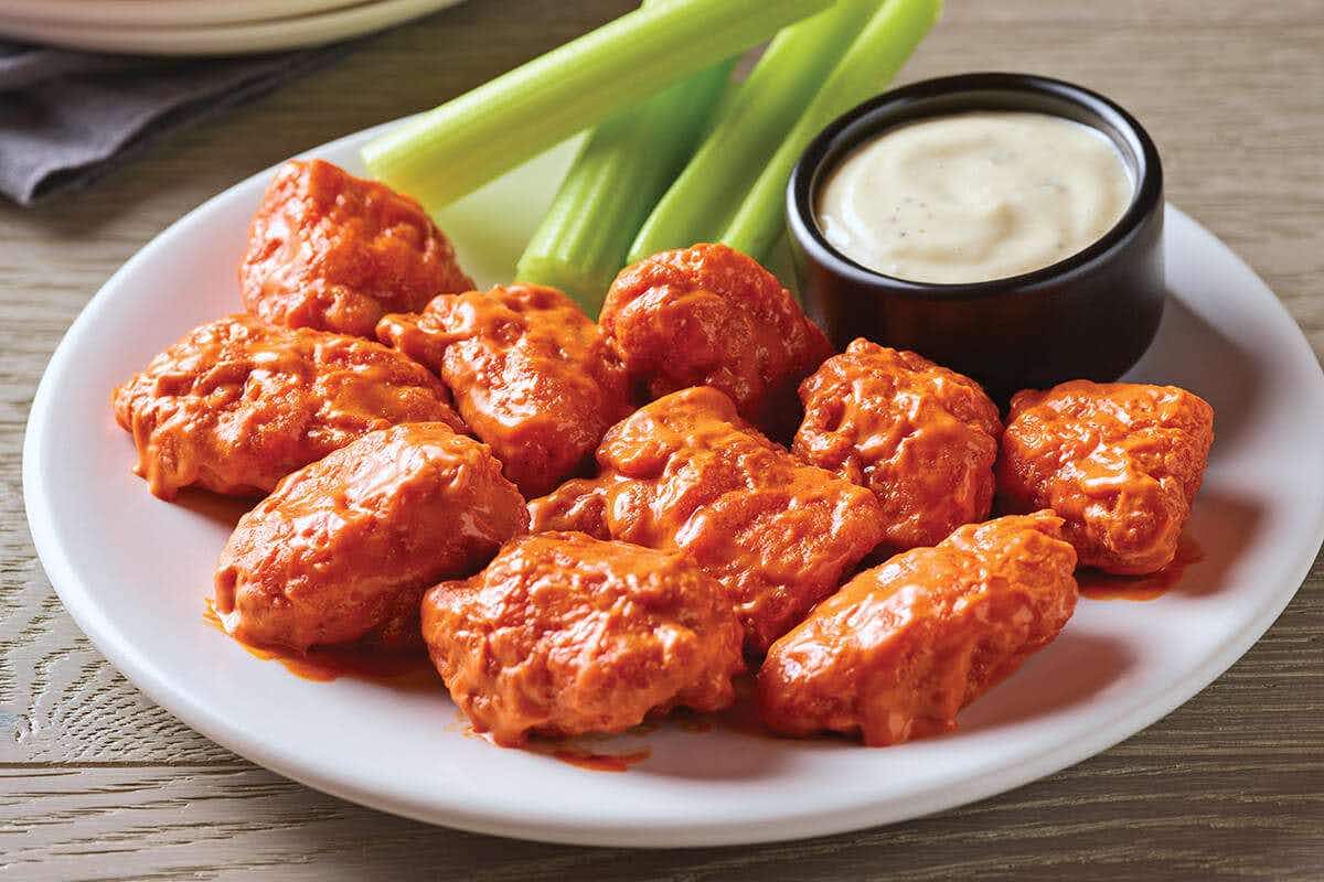 Boneless wings and celery sticks on a plate at Applebee's.