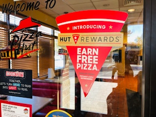 A sign for Pizza Hut's Hut Rewards