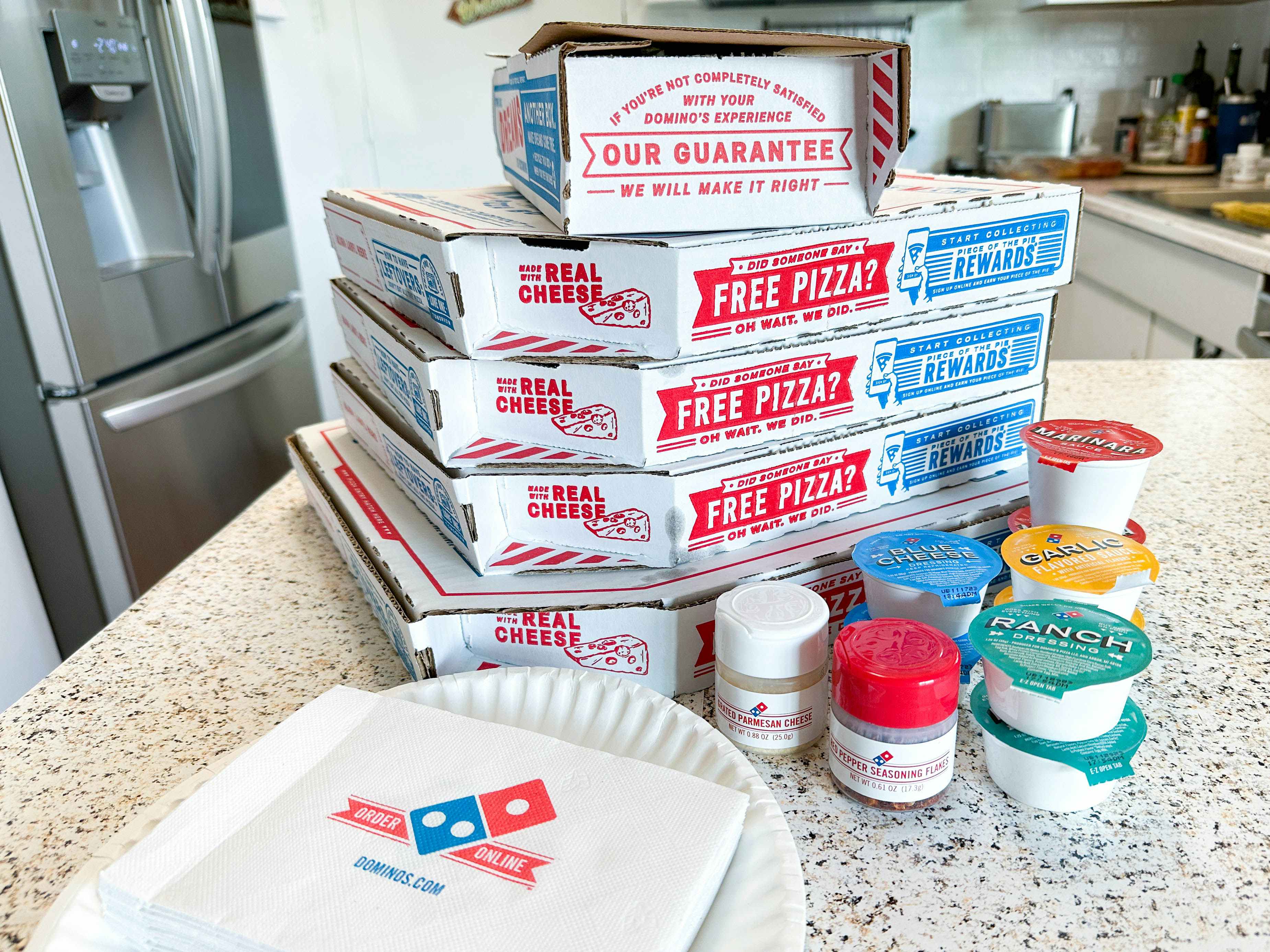 pizza boxes stacked up on a counter