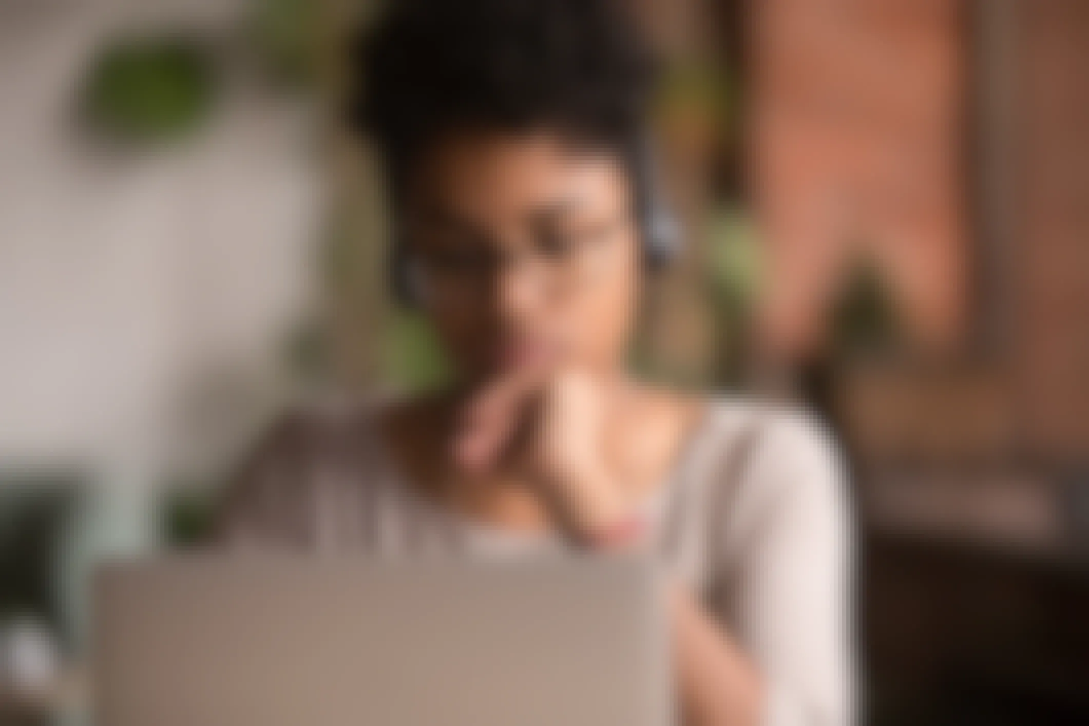 Focused african american girl student wearing headphones looking at laptop