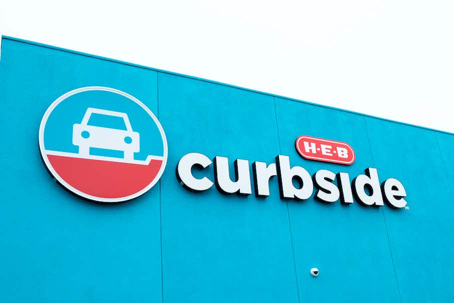 HEB grocery storefront with the word curbside and and car logo