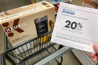 20% off Bed Bath and Beyond coupon held near a Keurig coffee maker in store