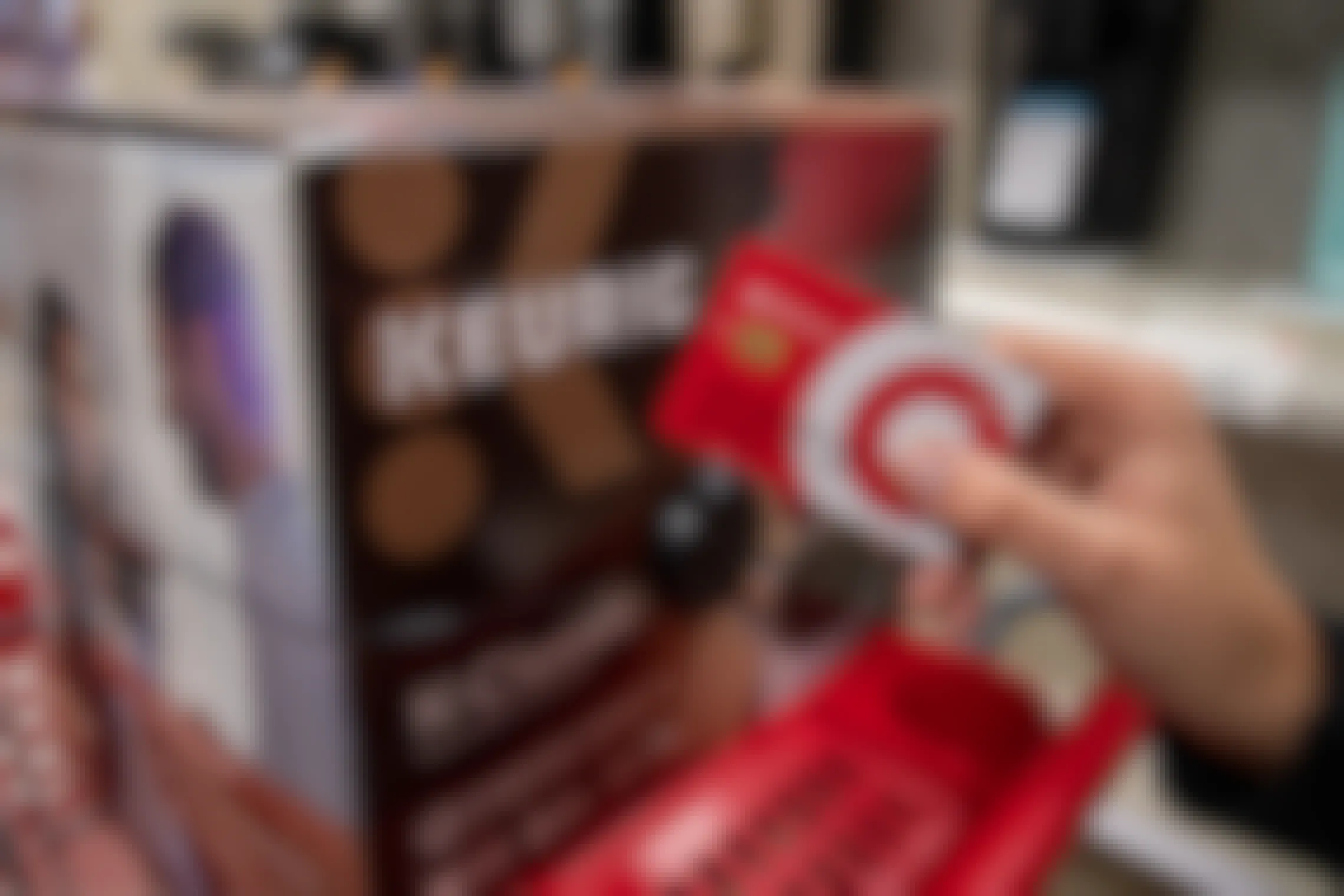 Target red card held next to a Keurig coffee maker inside Target.