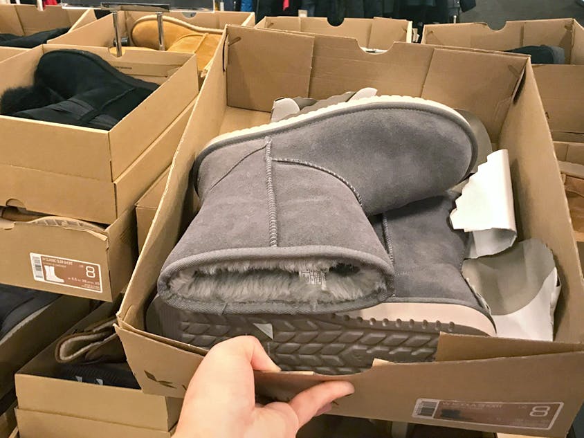 person grabbing ugg clearance boot box at dsw