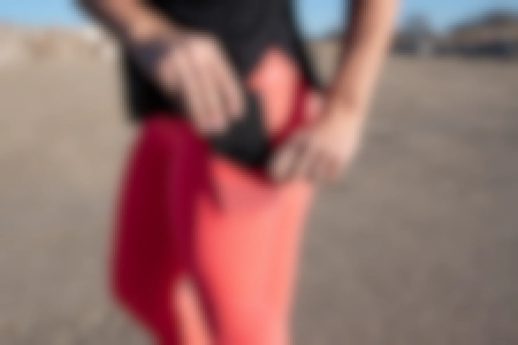 woman wearing pink Fabletics Mila capri pants with cell phone in pocket