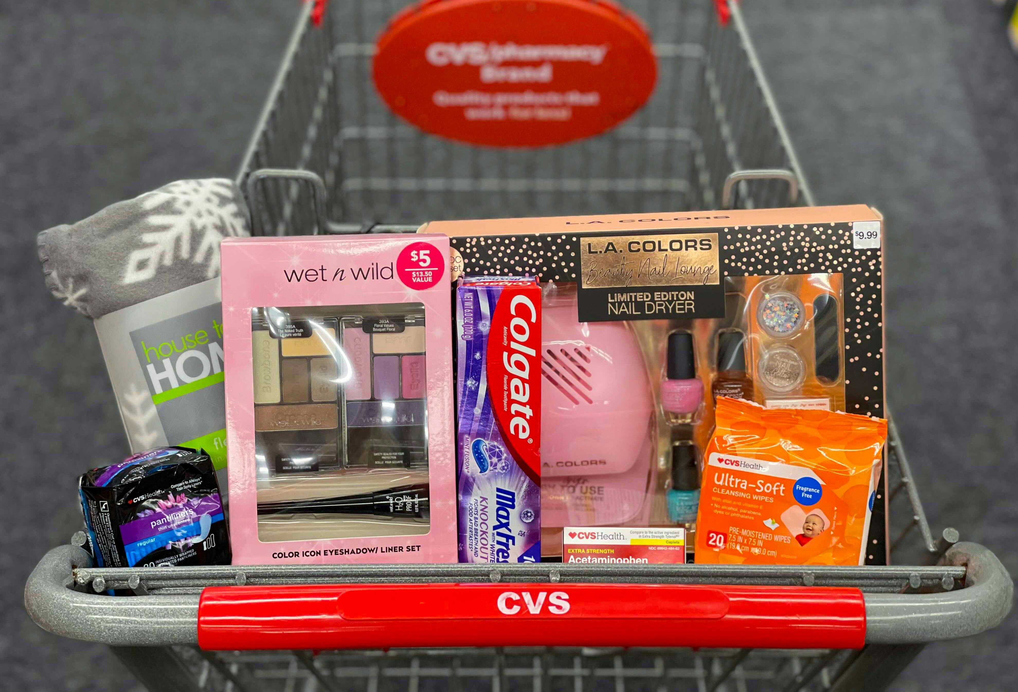 Beauty and personal care items in the basket of a CVS shopping cart.