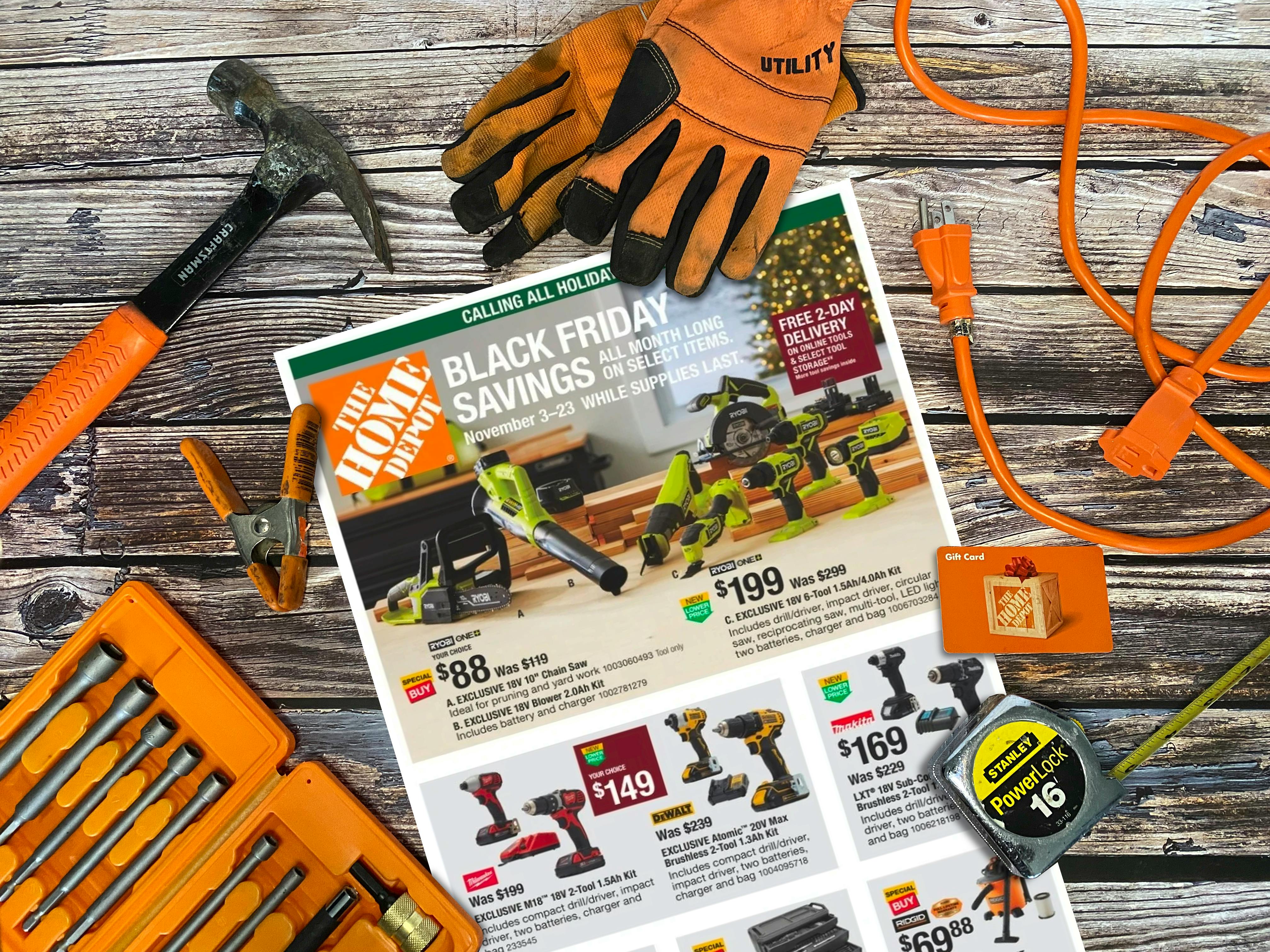 A Home Depot Black Friday savings advertisement on a table with some tools