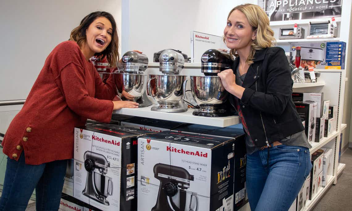 two women posing by the Kitchen Aid display at Kohl's