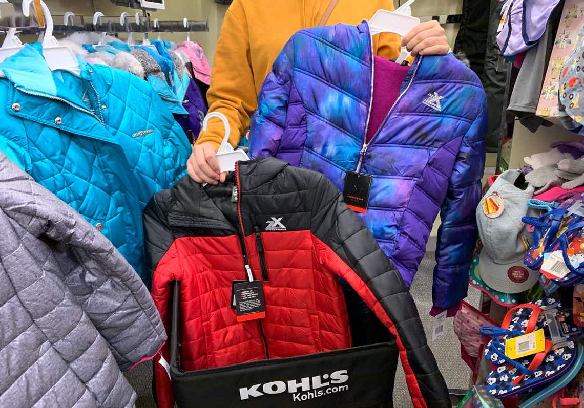 A person shopping for kids puffer coats at Kohl's