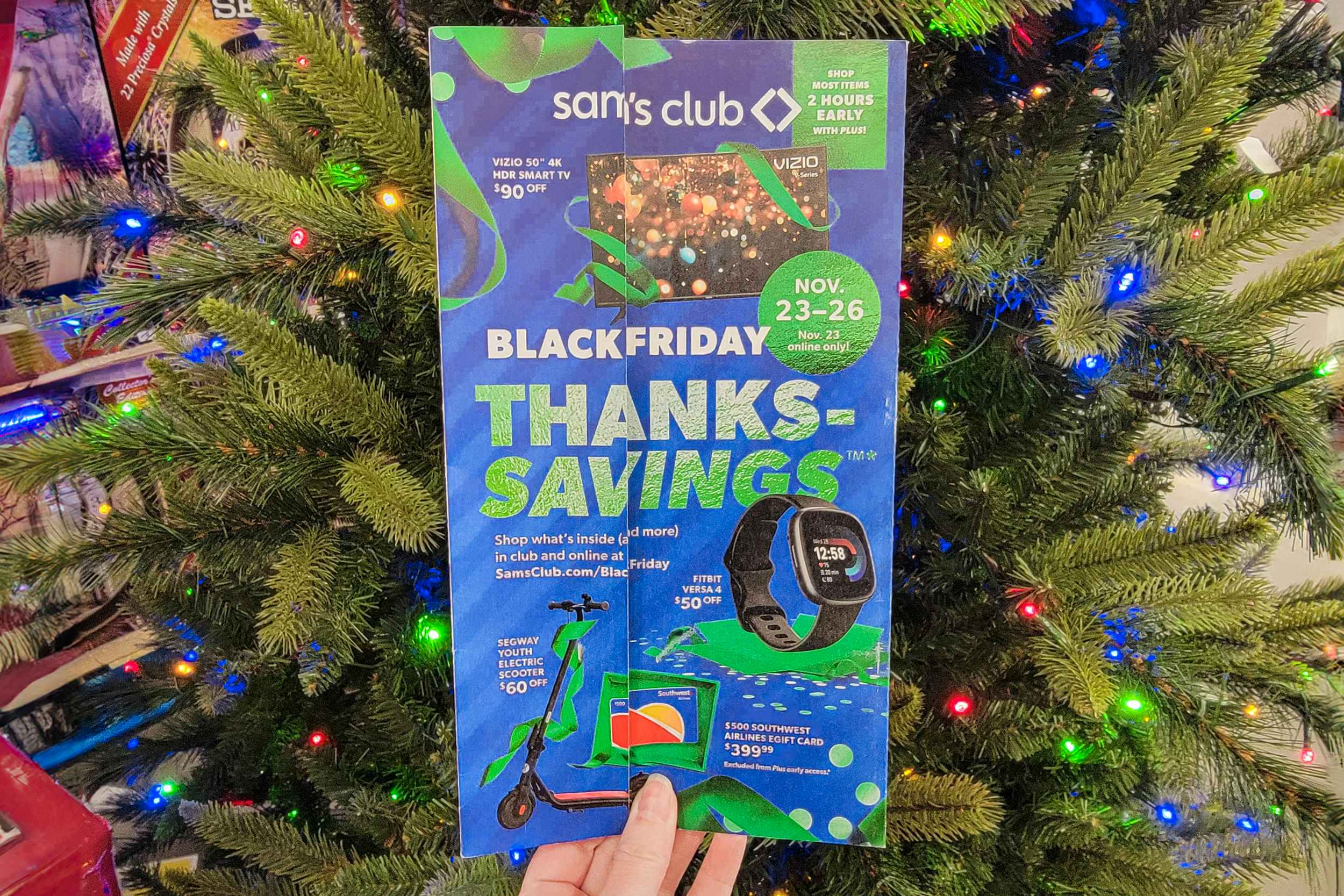 someone holding up the sam's club black friday ad
