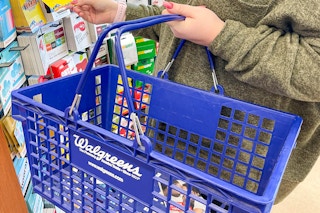 a woman holding a walgreens basket