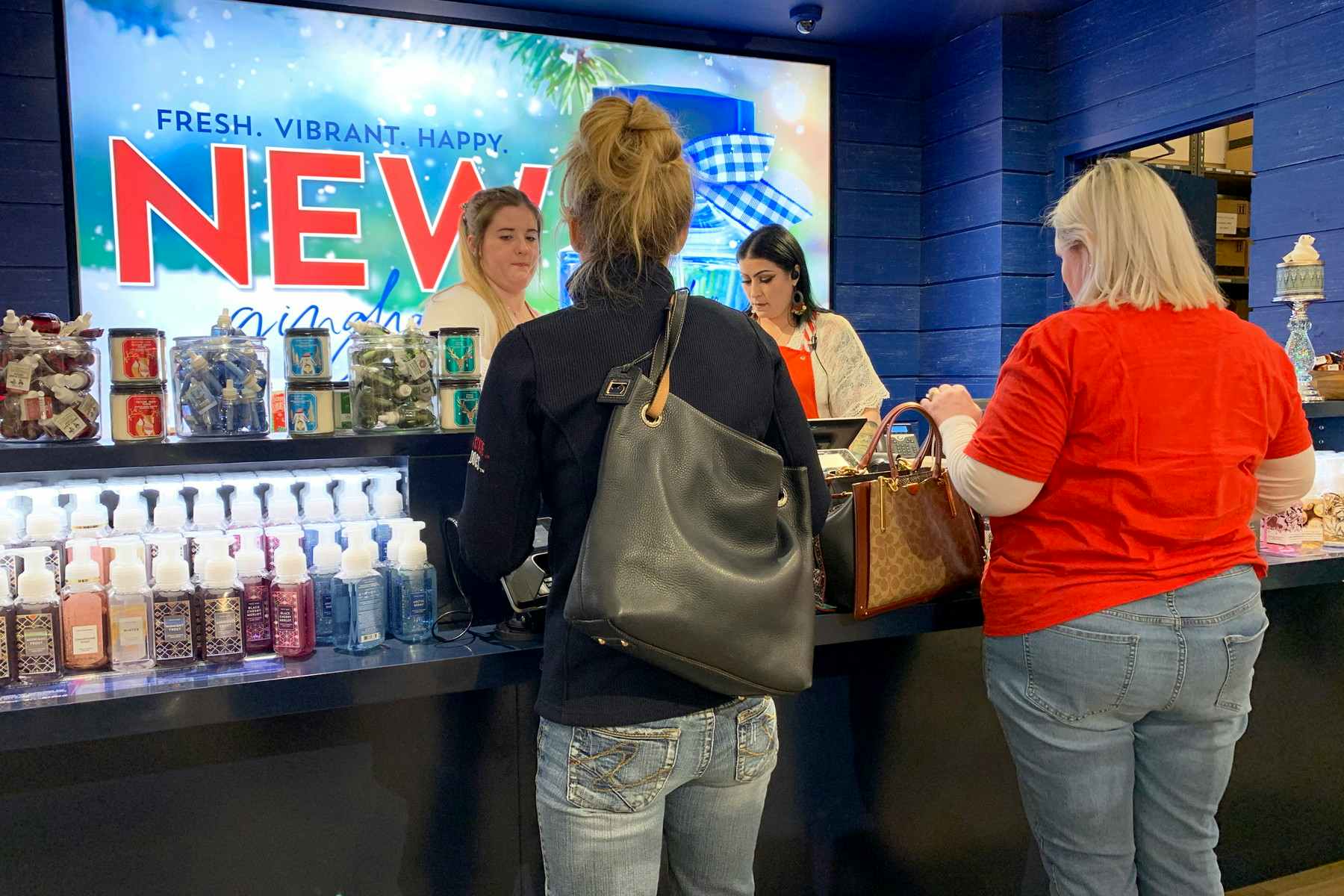 Customers standing at the counter inside Bath and Body Works 