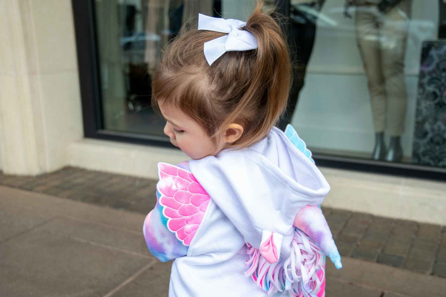 Toddler girl wearing a hoodie with a unicorn horn on top Unicorn hoodie FabKids