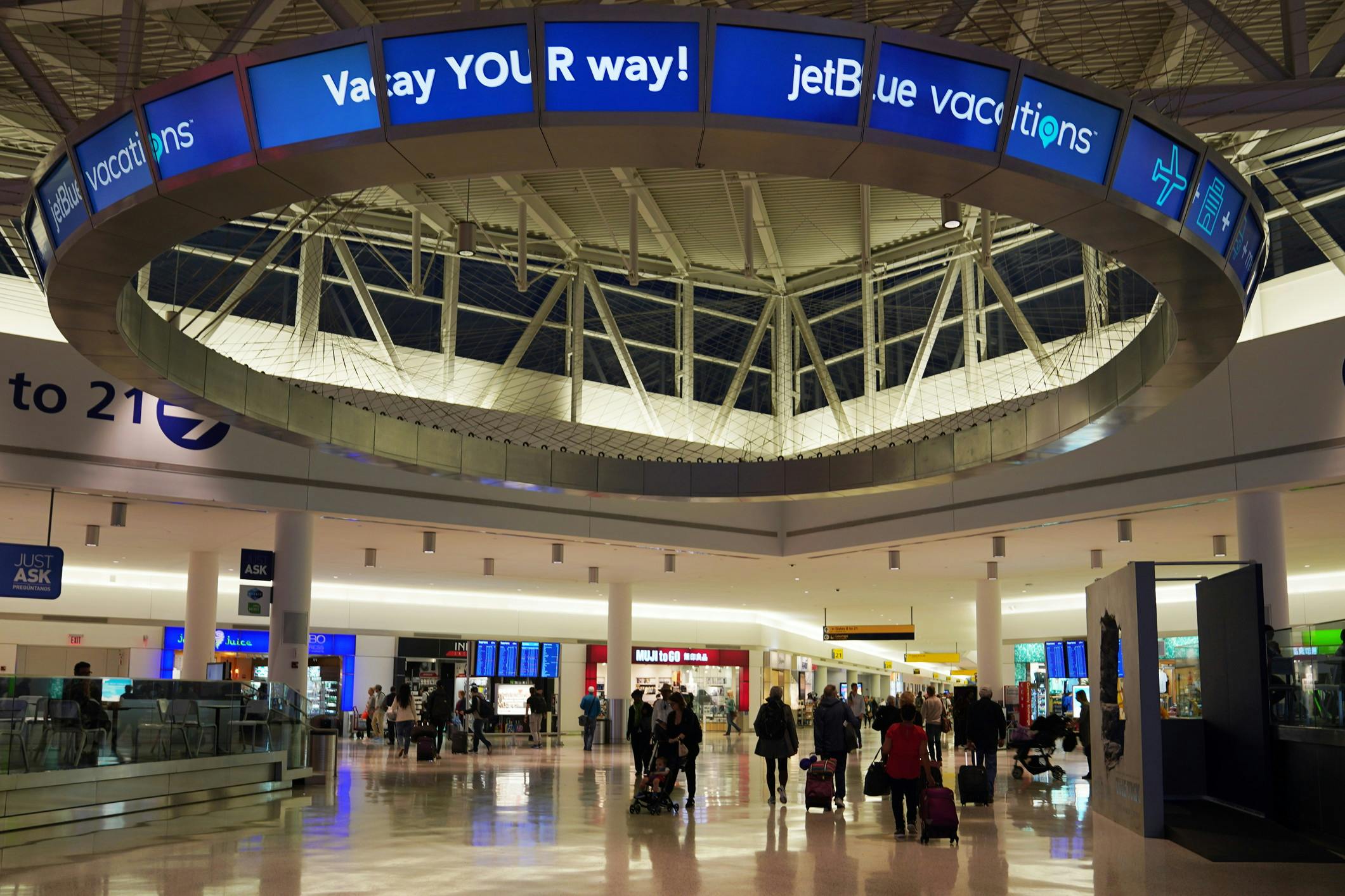 Airport featuring Jet Blue advertisement overhead