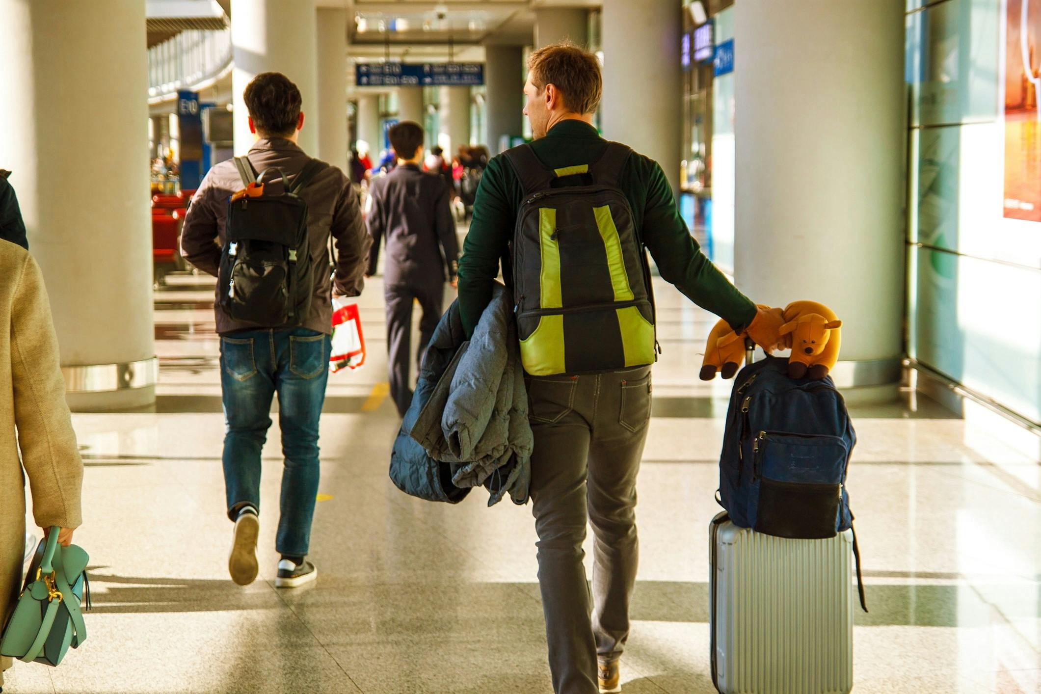 Man in airport wheeling bag