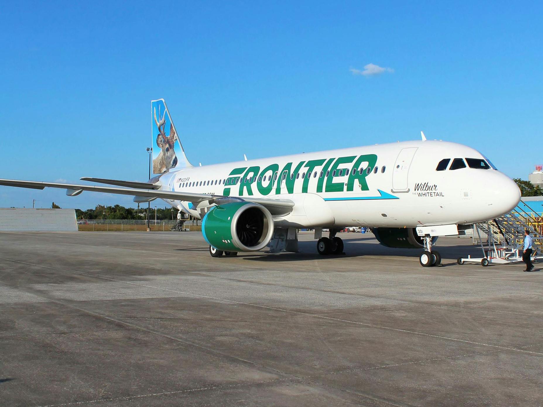 A Frontier plane parked on the tarmac.