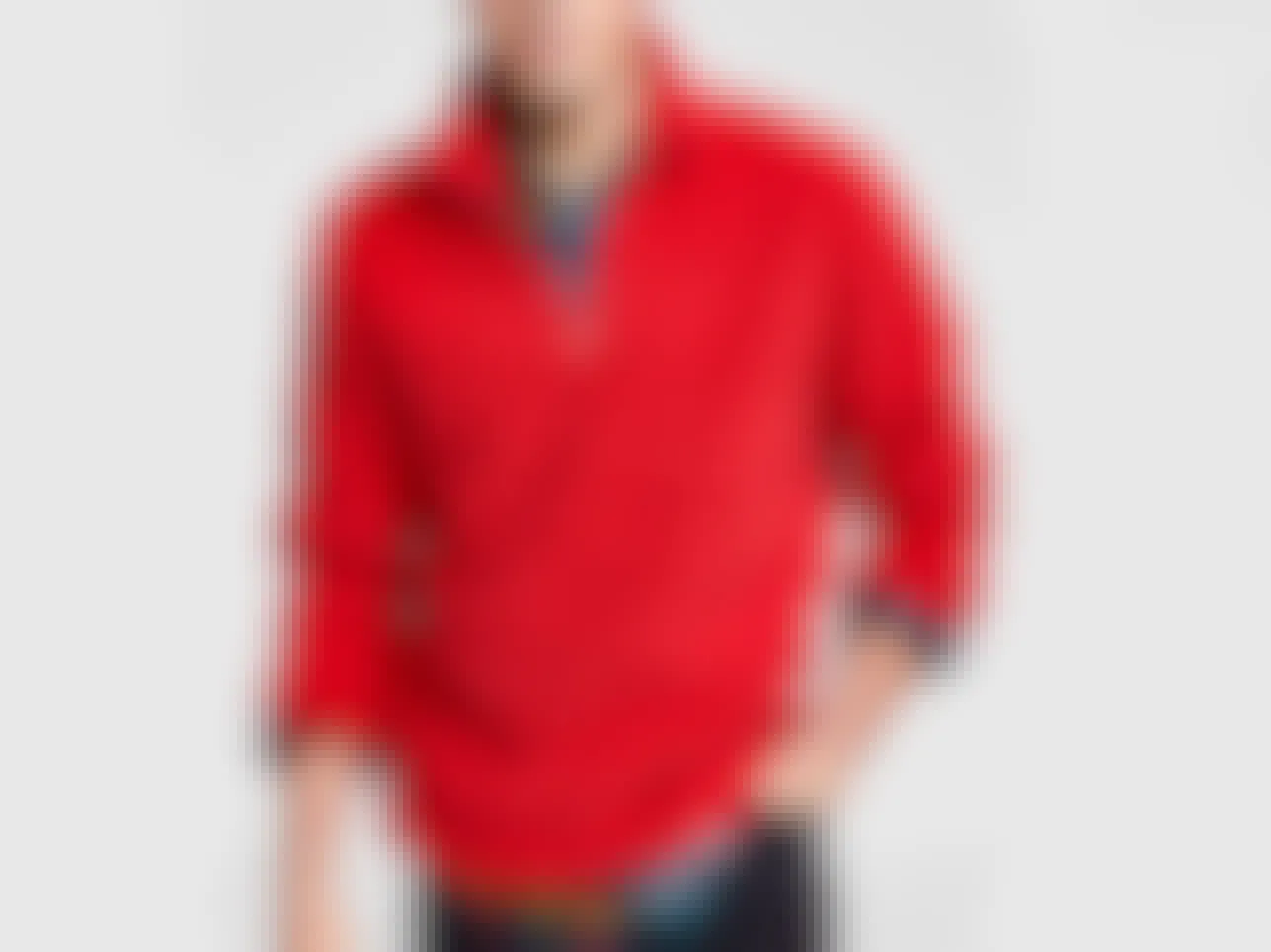 A male model wearing a red quarter-zip sherpa sweater.