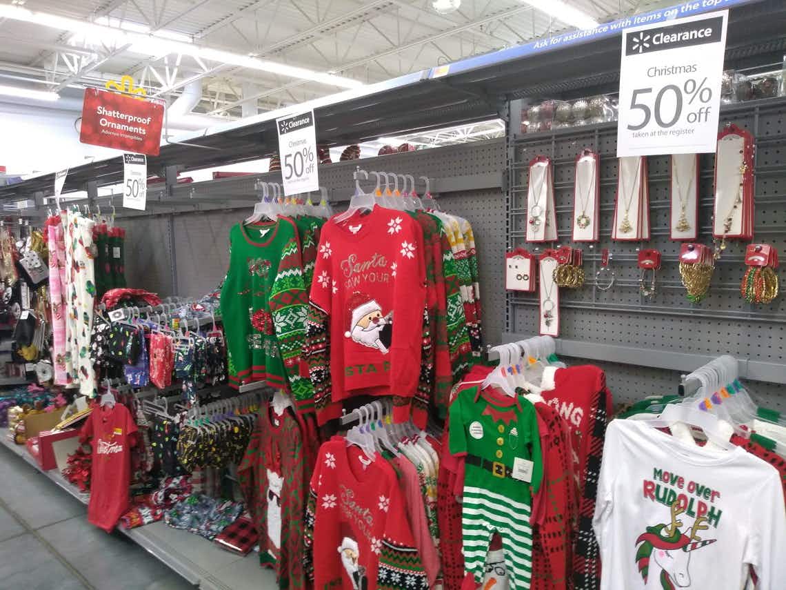 A rack of ugly Christmas sweaters at a Walmart store.