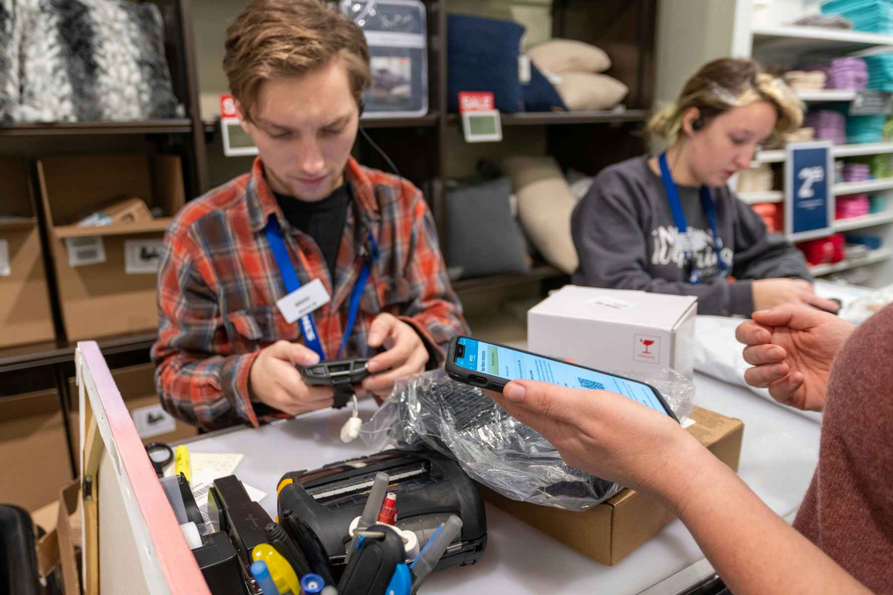 A Kohl's employee scanning in an Amazon return