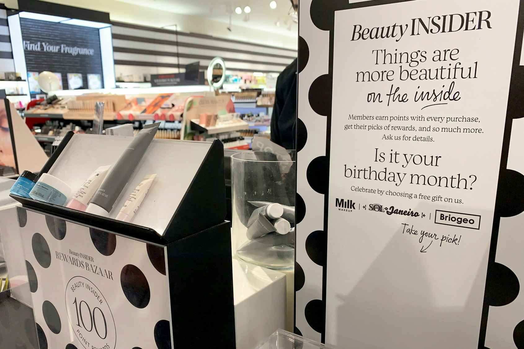 A sign advertising Beauty Insider program with Sephora products available to customers with redemption of rewards points.
