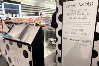 A sign advertising Beauty Insider program with Sephora products available to customers with redemption of rewards points.