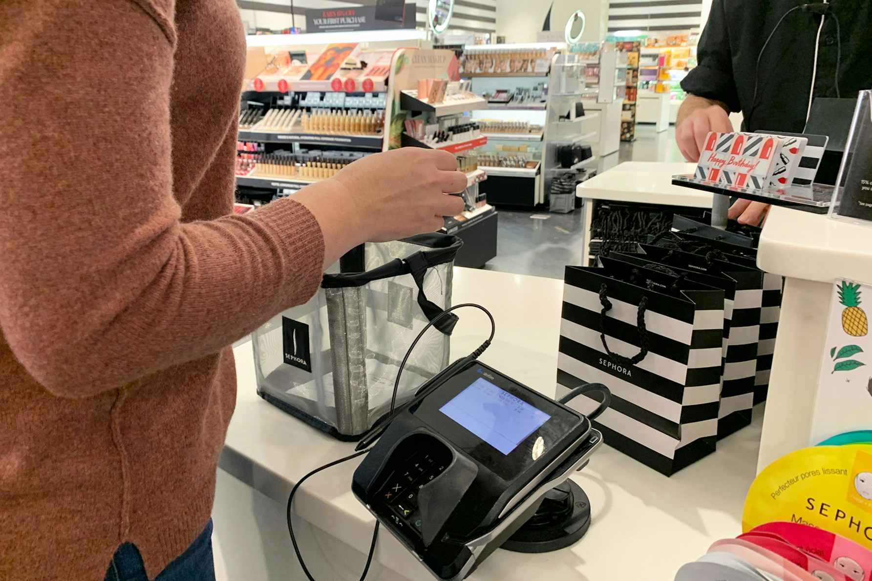 Woman standing at the checkout counter in Sephora.
