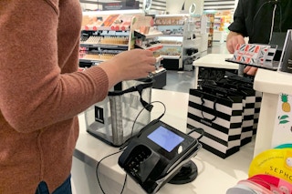 Woman standing at the checkout counter in Sephora.