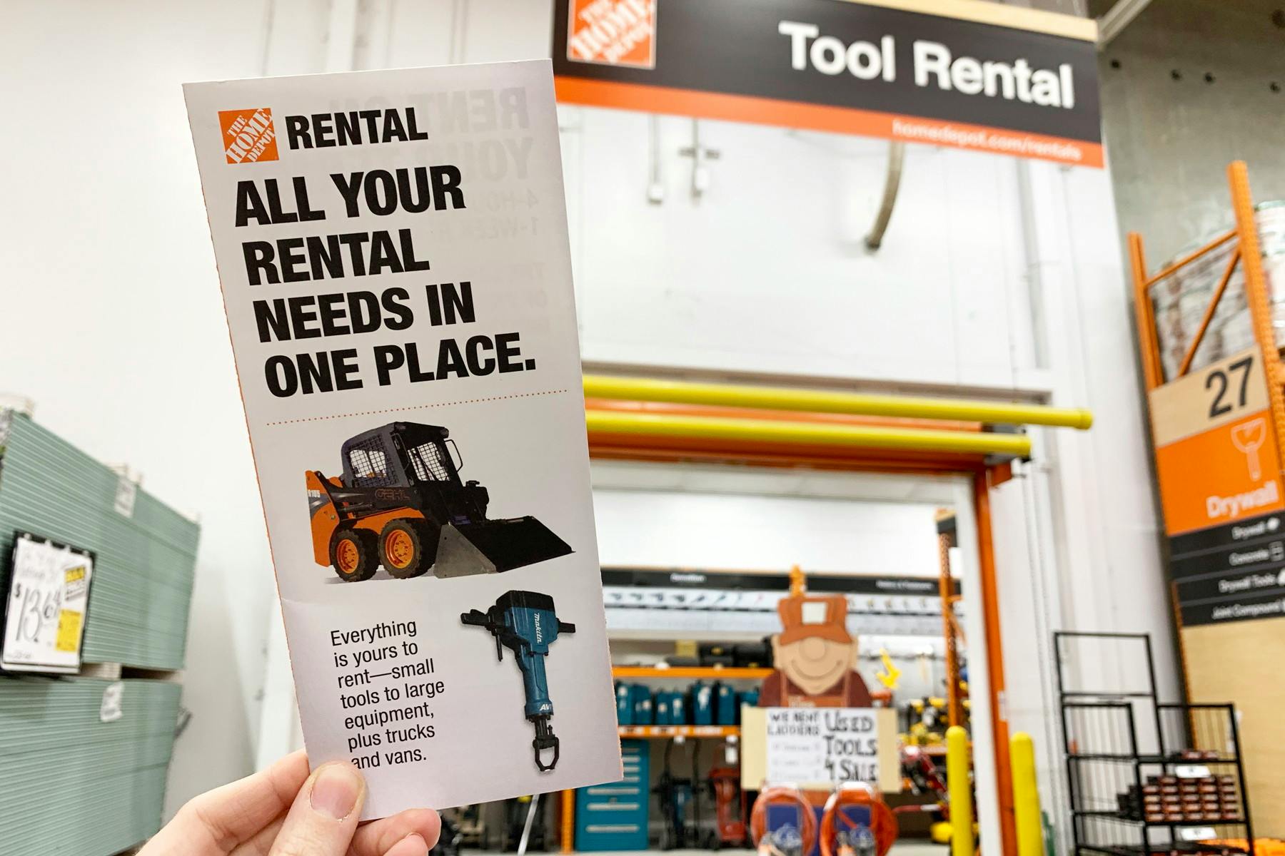 A tool rental pamphlet help up in front of the tool rental area in Home Depot.
