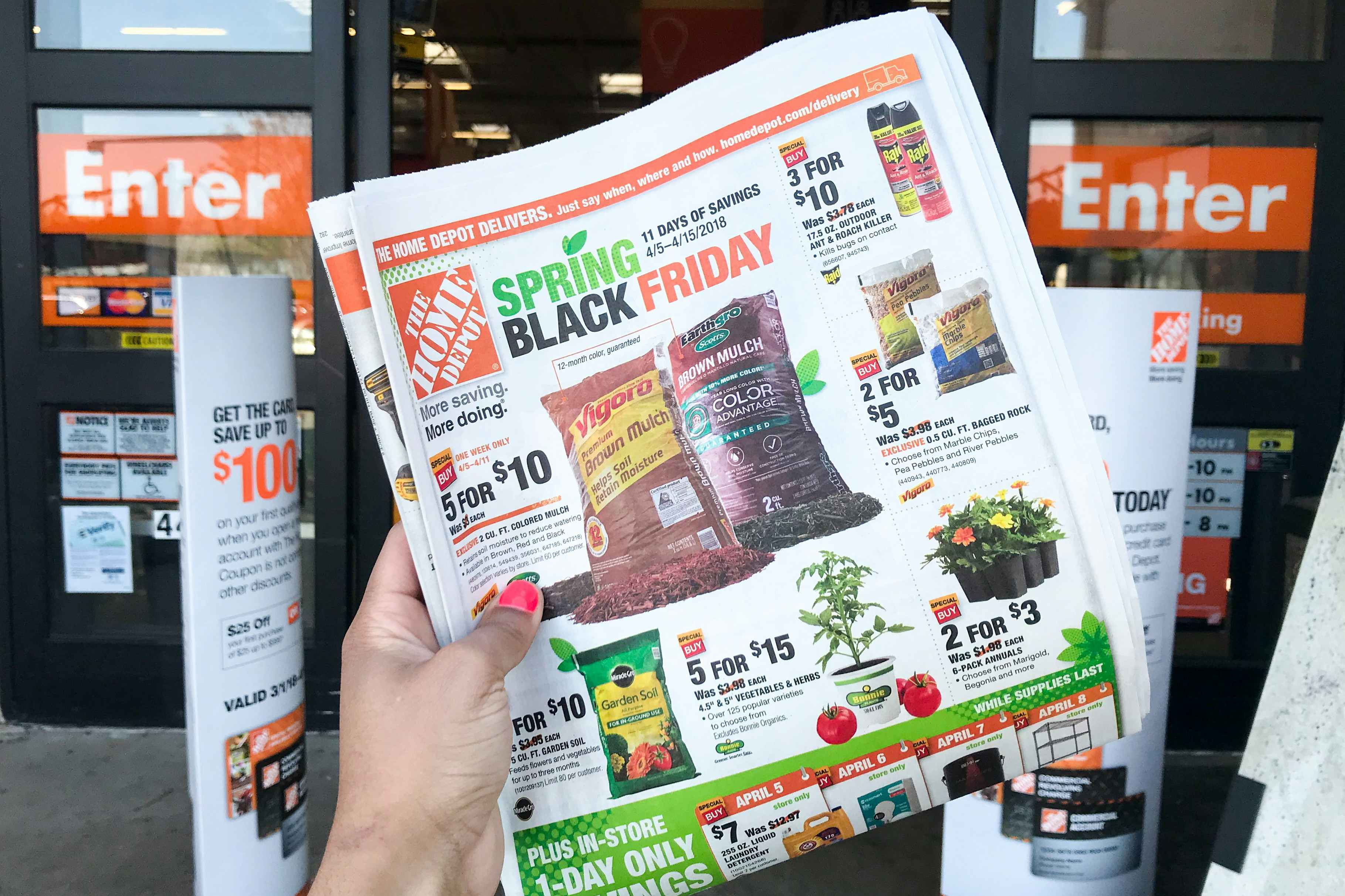 A Spring Black Friday advertisement held in front of the store entrance.