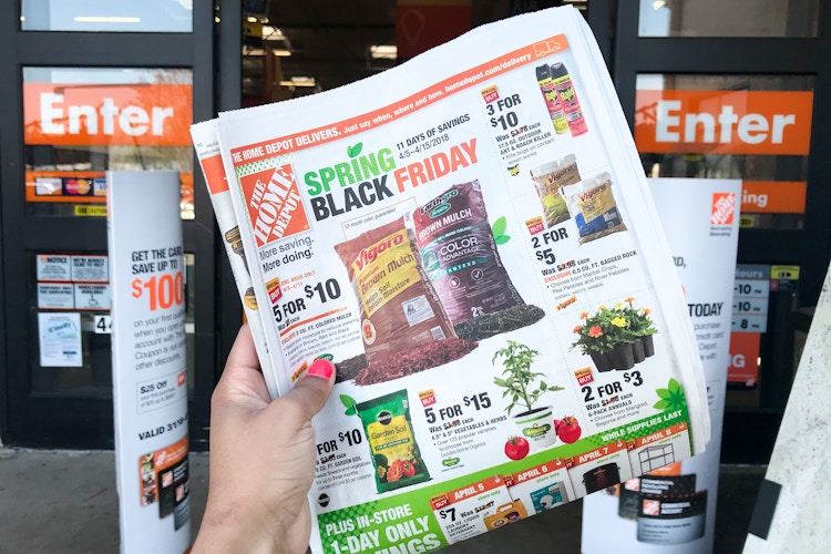 A Spring Black Friday advertisement held in front of the store entrance.