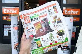 A Spring Black Friday advertisement held in front of the store entrance.