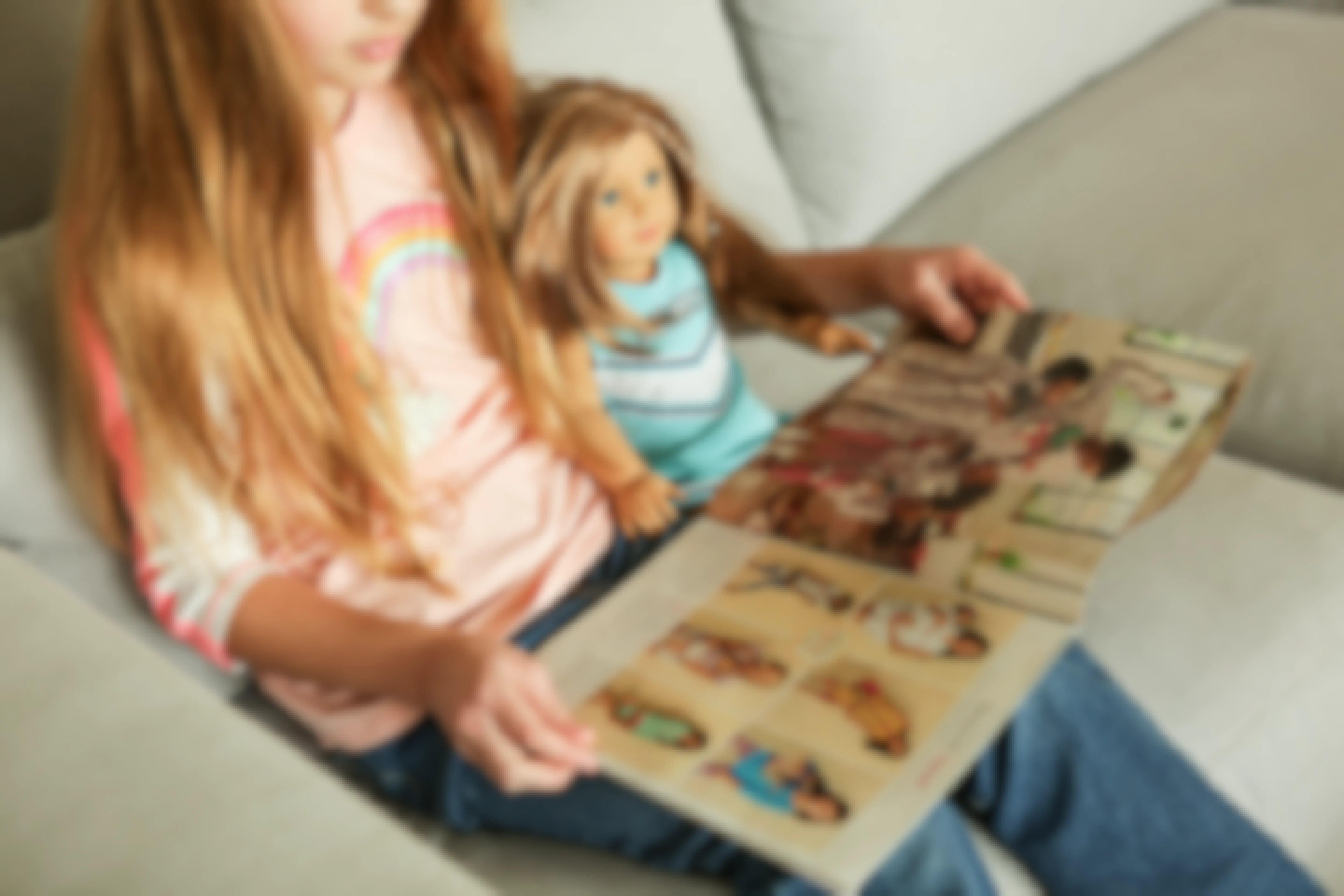 A girl and her American girl doll read the American Girl catalogue.