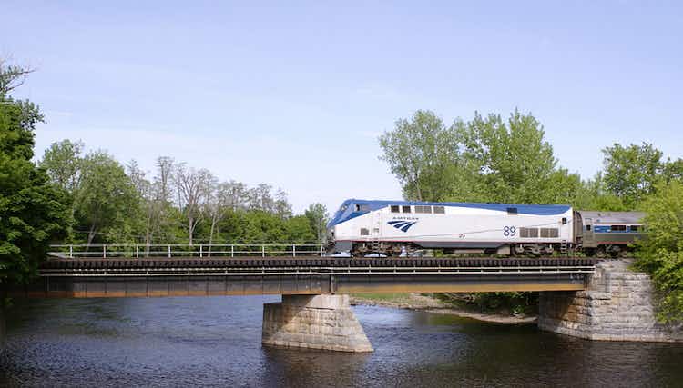 An Amtrak train goes over a bridge