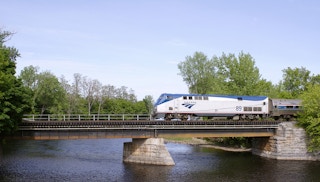 An Amtrak train goes over a bridge