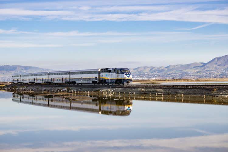 Alviso, San Jose, California, USA - Amtrak train passes through Alviso marsh on a sunny day